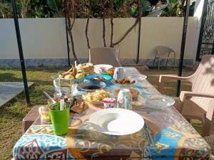 a table with a plate of food on it at Villa Set ma'at Nile view in Luxor