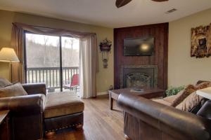 a living room with a couch and a fireplace at Rivers Edge Condo 902 in Helen