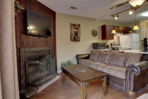 a living room with a couch and a fireplace at Rivers Edge Condo 902 in Helen