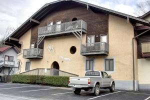 a truck parked in a parking lot in front of a building at Rivers Edge Condo 902 in Helen