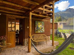 a porch with a hammock in a house at Casa Nuestra - Room with Private Bathroom in Shared House in Urubamba