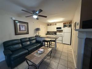 a living room with a leather couch and a table at Rivers Edge 803 in Helen