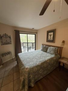 a bedroom with a large bed and a balcony at Rivers Edge 803 in Helen