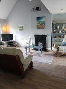 a living room with a couch and a fireplace at Old Killarney in Killarney