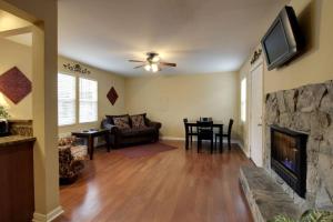 a living room with a couch and a fireplace at Bavarian Brook Condo 10 in Helen