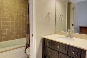 a bathroom with a sink and a toilet and a tub at Bavarian Brook Condo 16 in Helen
