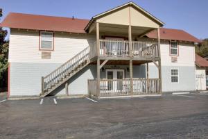 a large white building with a deck and a balcony at Bavarian Brook Condo 16 in Helen