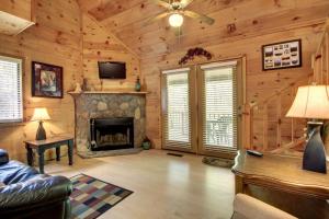 a living room with a fireplace in a log cabin at Bavarian Hideaway 24 in Sautee Nacoochee