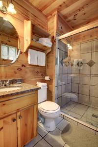 a bathroom with a toilet and a shower in a cabin at Bavarian Hideaway 24 in Sautee Nacoochee +12 photos