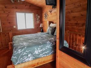 a bedroom with a bed in a log cabin at Bavarian Hideaway 24 in Sautee Nacoochee