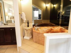 a large bathroom with a tub and a sink at Rivers Edge Condo 101 in Helen