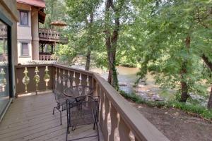 a balcony with a table and chairs on a house at Rivers Edge Condo 101 in Helen +14 photos