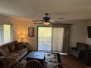 a living room with a couch and a table at Rivers Edge 504 in Helen +4 photos