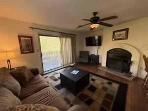 a living room with a couch and a fireplace at Rivers Edge 504 in Helen