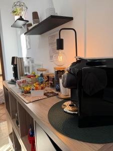 a counter top with a coffee maker on top of it at Residenza Bibiena - Lake View - in Mantova