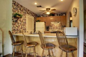 a kitchen with three chairs sitting at a counter at Rivers Edge 504 in Helen