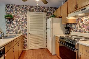 a kitchen with a white refrigerator and a sink at Rivers Edge 504 in Helen