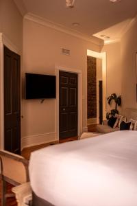 a bedroom with a bed and a flat screen tv at Old City Loft Knoxville in Knoxville
