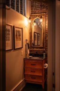 a bathroom with a sink and a mirror at Old City Loft Knoxville in Knoxville +39 photos