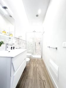 a white bathroom with a toilet and a sink at Napoleon in Tropea +84 photos