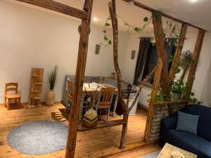 a living room with a table and a blue couch at Zum Jandel in Boppard