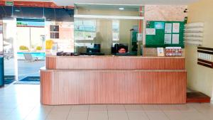 a counter in a restaurant with a person behind it at Golden Beach Hotel in Fortaleza +21 photos