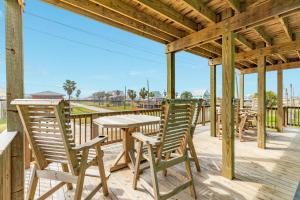 a patio with a table and chairs on a deck at Minutes to the Sand Spacious beautiful relaxing in Surfside Beach