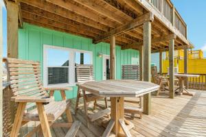 a deck with a wooden table and chairs at Minutes to the Sand Spacious beautiful relaxing in Surfside Beach +17 photos