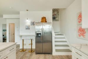 a kitchen with a stainless steel refrigerator and a staircase at Minutes to the Sand Spacious beautiful relaxing in Surfside Beach