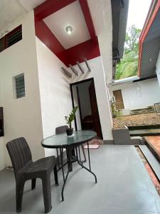 a patio with a table and chairs in front of a house at NVH Coron Palawan in Coron