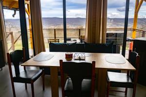 a table and chairs with a view of the mountains at Cabana Valea Brazilor in Tutana