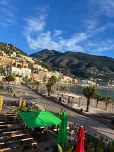 a view of a beach with tables and umbrellas at HENRY BENNEt in Menton