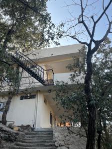 a building with stairs leading up to it at Yugm Homes Rishikesh in Narendranagar +13 photos