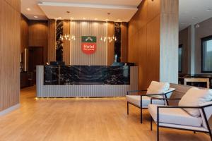 a lobby with two chairs and a reception desk at Hotel Bergozza in Rio do Sul
