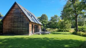 an old wooden church with a grass yard at Kauperhof in Burg