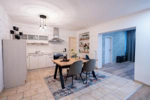 a kitchen and dining room with a table and chairs at Central Gerolstein Panorama Apartment in Gerolstein