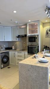 a kitchen with white cabinets and a counter top at برج داماك الجوهرة جدة - Damac al jawharah tower in Jeddah