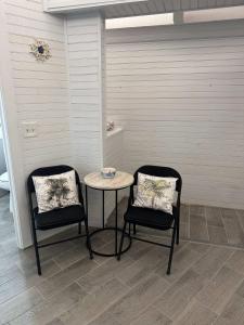 two chairs and a table in a room at Treehouse Private Village at Barnacle Resort in Big Pine Key