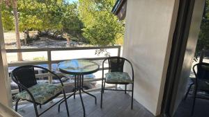 a table and chairs on a balcony with a view at Treehouse Private Village at Barnacle Resort in Big Pine Key