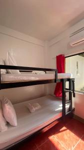 two bunk beds in a room with a window at NVH2 Coron Palawan in Coron