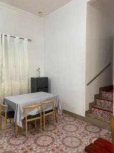 a dining room with a table and two chairs at NVH2 Coron Palawan in Coron