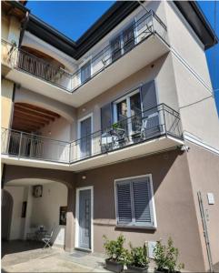 a large building with balconies and plants on it at Residence Jasmin 2P B in Turate