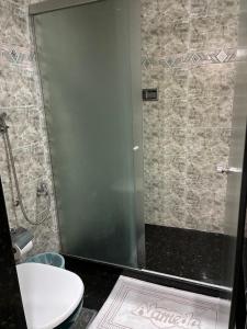 a bathroom with a glass shower with a toilet at Hotel Alameda - Adults Only in Rio de Janeiro