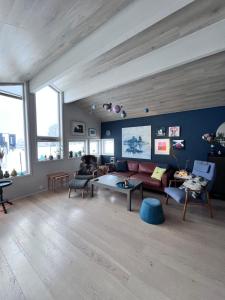 a living room with a couch and a table at Modern Luxplace with Northern Light view in Tromsø