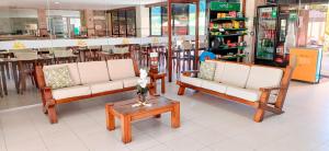 a store with three chairs and a coffee table at Golden Beach Hotel in Fortaleza