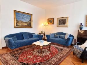 a living room with two blue couches and a table at Mancini 1 - Gran Madre in Turin