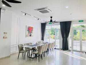 a dining room with a table and chairs at Happy House in Cam Lâm
