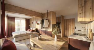 a living room with a kitchen and a room with a table at Dirtlergut in Haus im Ennstal