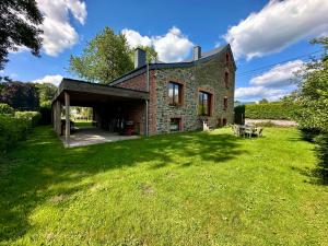 an old brick house with a grass yard at La Méliraude in Daverdisse