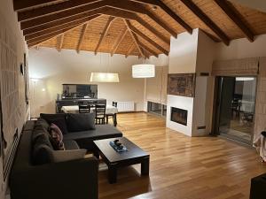 a living room with a couch and a table at V Mira Luxury Villa in Tragaki